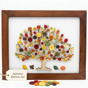 May include: A framed artwork featuring a tree crafted from colorful buttons in shades of red, orange, yellow, and green. The wooden frame surrounds a white background with the text "Autumn Button Art" on a tag. Decorative leaves and a pumpkin are also included.