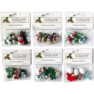 May include: Six packages of Christmas themed buttons. Each package contains a variety of buttons featuring snowmen, snowflakes, trees, and other wintery designs. The packages are labeled "Buttons Galore & More" and "Christmas Collection".