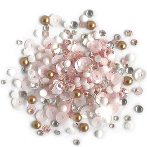 May include: A mix of pink, white, and gold sequins, beads, and rhinestones. These embellishments are perfect for adding sparkle and dimension to crafts, jewelry, and other projects.