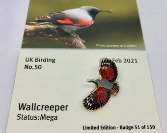 May include: A Wallcreeper pin badge, a limited edition badge number 51 of 150. The pin features a red, black, and white bird with a gray head and a silver metal frame. The pin is on a white card with the text "UK Birding No. 50", "Wallcreeper", "Status: Mega", "Feb 2021", and "Limited Edition - Badge 51 of 150".