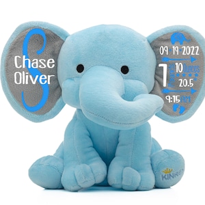 May include: A light blue plush elephant with gray ears. The ears are personalized with the name "Chase Oliver" and the date "09-19-2022", time "9:15 AM", weight "7 lbs 10 ounces", and length "20.5 inches".