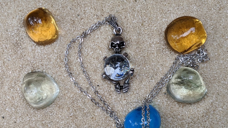 Necklace of a Skeleton Holding a Sphere of Jade...or Quartz, Obsidian, Blue Sandstone, Goldstone Clear Quartz