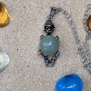 Necklace of a Skeleton Holding a Sphere of Jade...or Quartz, Obsidian, Blue Sandstone, Goldstone Jade