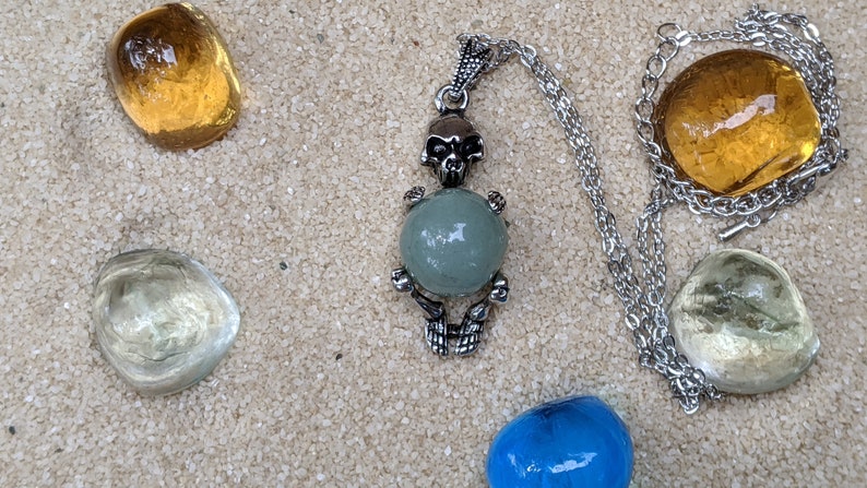 Necklace of a Skeleton Holding a Sphere of Jade...or Quartz, Obsidian, Blue Sandstone, Goldstone Jade