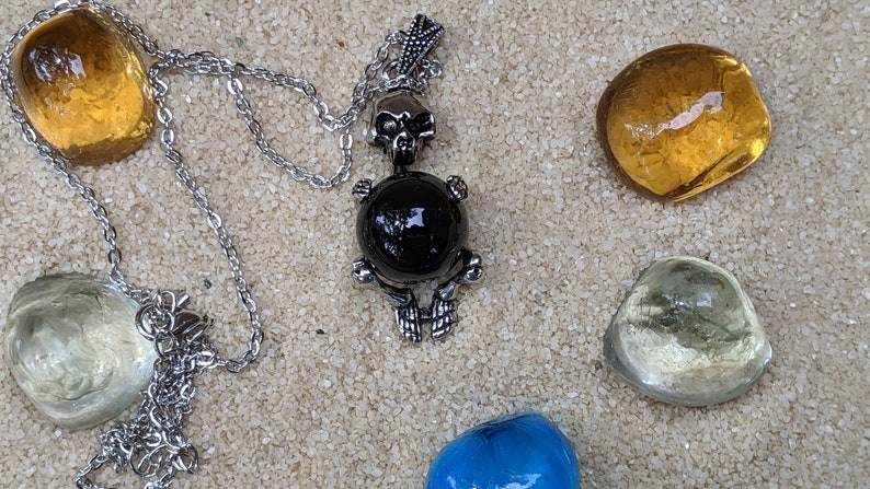 Necklace of a Skeleton Holding a Sphere of Jade...or Quartz, Obsidian, Blue Sandstone, Goldstone Obsidian