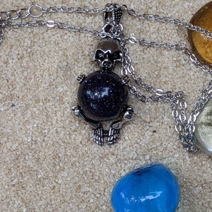 Necklace of a Skeleton Holding a Sphere of Jade...or Quartz, Obsidian, Blue Sandstone, Goldstone Blue Sandstone
