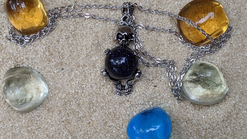 Necklace of a Skeleton Holding a Sphere of Jade...or Quartz, Obsidian, Blue Sandstone, Goldstone Blue Sandstone