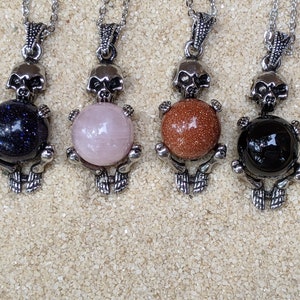 Necklace of a Skeleton Holding a Sphere of Jade...or Quartz, Obsidian, Blue Sandstone, Goldstone image 1