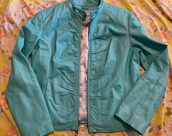 May include: A teal leather jacket with a zipper closure and a stand-up collar.