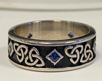 Handmade trinity design sapphire wedding band .