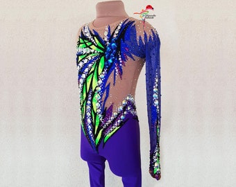 May include: A purple and nude leotard with long sleeves. The leotard has a colorful design with green, blue, and black accents. The design features rhinestones and a geometric pattern.