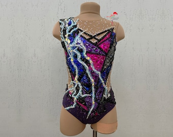 May include: A purple, black, and blue leotard with a geometric design and rhinestones. The leotard has a mesh back and a scoop neckline.