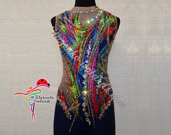 May include: A colorful leotard with a rainbow design and rhinestones. The leotard is sleeveless and has a scoop neck. The leotard is made of a sheer fabric and has a navy blue base.