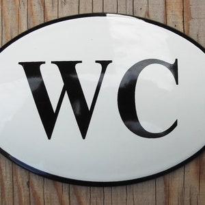 Classic Enamel WC sign. Black text on a white background. 12x8cm. Oval