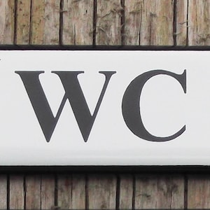 Classic Enamel WC Toilet sign. Black Text on a White background, 10x3cm.