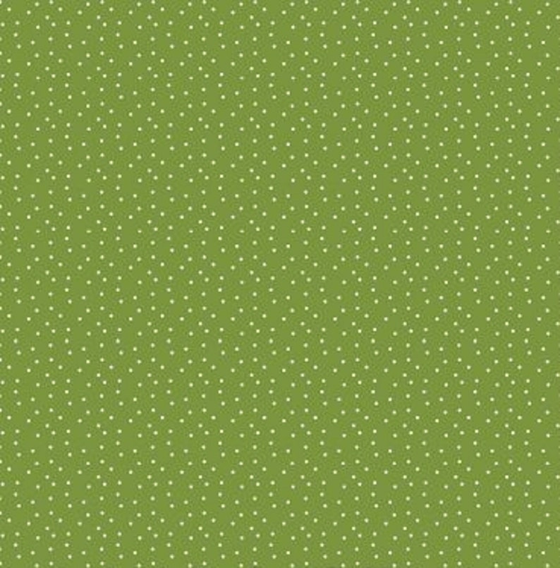 May include: A green fabric with a white polka dot pattern.