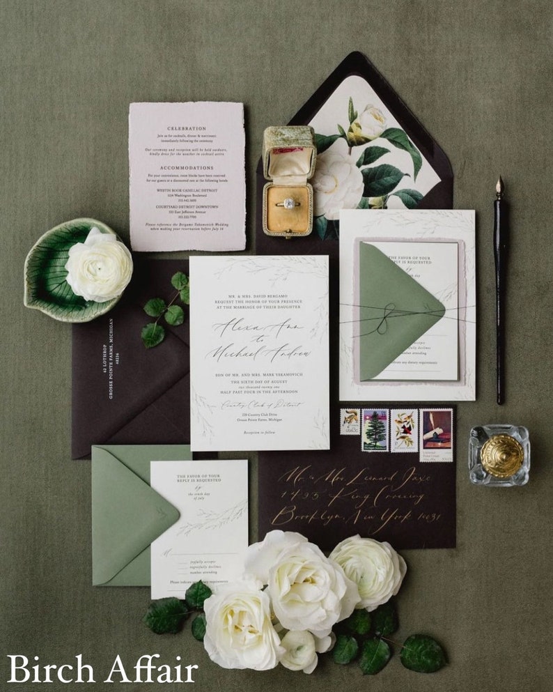May include: A wedding invitation suite with a green and white color scheme. The invitation features a delicate floral design and the text "Alexa and Michael Andre". The RSVP card is a simple white card with a green envelope. The invitation is accompanied by a small box with a ring inside.