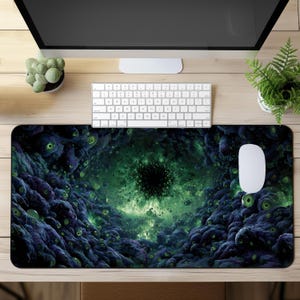 May include: A rectangular desk mat featuring a surreal, eye-filled design in shades of green and purple. The central focus is a dark, circular void, surrounded by a swirling, cloud-like pattern. A white mouse and keyboard are on the desk.