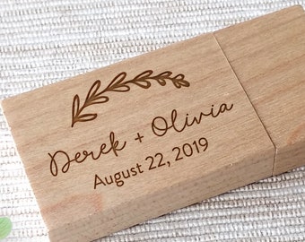 May include: A wooden USB flash drive with a floral design and the text "Derek + Olivia August 22, 2019" engraved on it.