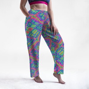 May include: Vibrant, patterned pants in shades of blue, green, pink, and yellow. The pants feature a unique, abstract design. The pants have pockets and a comfortable fit, suitable for casual wear.