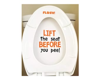 Könnte beinhalten: Ein weißer Toilettensitz mit einem orangefarbenen und schwarzen Aufkleber, auf dem steht "FLUSH! LIFT the seat BEFORE you pee!"