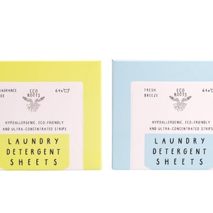 Puede incluir: Dos cajas de hojas de detergente para la ropa. La caja de la izquierda es amarilla y dice "Sin fragancia" y "Eco Roots". La caja de la derecha es azul claro y dice "Brisa fresca" y "Eco Roots". Ambas cajas dicen "Hipoalerg&eacute;nico, ecol&oacute;gico y ultraconcentrado" y "Hojas de detergente para la ropa".