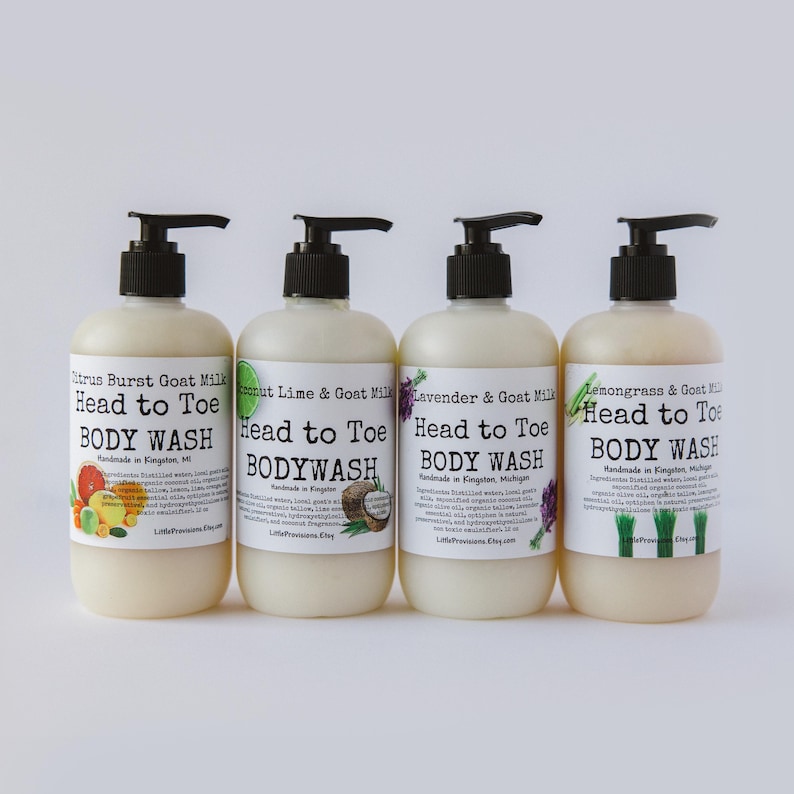 Op de afbeelding: Vier flessen douchegel met pompjes. De flessen zijn gelabeld met verschillende geuren: Citrus Burst Goat Milk, Coconut Lime & Goat Milk, Lavender & Goat Milk en Lemongrass & Goat Milk. Elke fles heeft een label met de tekst "Head to Toe Body Wash" en "Handmade in Kingston, MI".