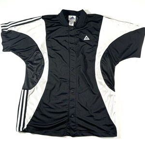 May include: Black and white short-sleeved button-up shirt with a curved design and the Adidas logo. The shirt has a black background with white stripes and a white curved design.