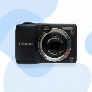 May include: Black Canon digital camera with a silver lens ring. The camera has a 5x optical zoom and a 16.0 megapixel resolution. The lens has a focal length of 5.0-25.0mm and an aperture of f/2.8-6.9.