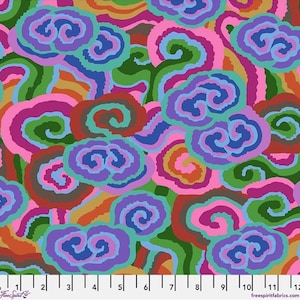 May include: A fabric swatch featuring a repeating pattern of swirling, cloud-like shapes in vibrant shades of purple, pink, green, orange, and blue. A white ruler at the bottom shows measurements from 0 to 12 inches for scale.