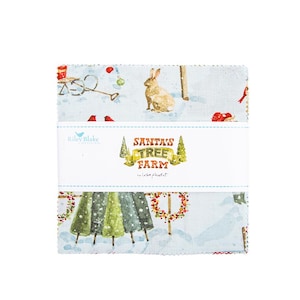 May include: A stack of fabric squares featuring a winter scene with a rabbit, cardinals, and Christmas trees. The fabric is light blue with a snowy landscape design. The label reads "SANTA'S TREE FARM" by Lisa Audit.