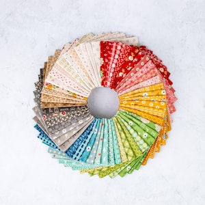 May include: A collection of 24 fabric squares in a variety of colors and patterns, arranged in a circle. The fabrics feature floral, geometric, and abstract designs.