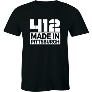 May include: Black t-shirt with white text that reads "412 Made in Pittsburgh".