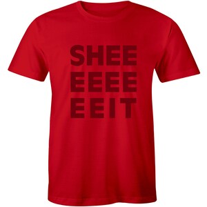 May include: Red t-shirt with the text "SHEE EEEE EEIT" printed in black.