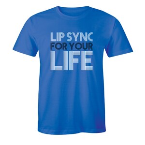 May include: A royal blue t-shirt with the text "Lip Sync For Your Life" in white and black lettering. The text is stylized with multiple lines.
