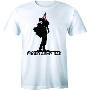 May include: A white t-shirt with a black silhouette of a soldier carrying a child with an American flag. The text "PROUD ARMY DAD" is printed below the silhouette.