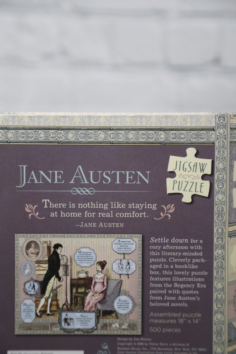 May include: A purple box with a Jane Austen jigsaw puzzle. The box features a quote from Jane Austen, "There is nothing like staying at home for real comfort." The puzzle is 500 pieces and measures 18 inches by 14 inches.