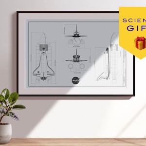 May include: A framed black and white blueprint style illustration of the Space Shuttle. The illustration shows the shuttle from different angles, including top, front, and side views. The illustration is labeled with "NASA" and includes measurements in inches.