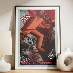 May include: A vintage Soviet propaganda poster with a red and white color scheme. The poster features a group of people marching forward, with the text "1905 ГОД" and "ПУТЬ К ОКТЯБРЮ" visible.