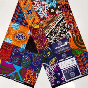May include: A colourful fabric with a patchwork design featuring various geometric and floral patterns in shades of orange, blue, green, red, and purple. The fabric is labelled "Prime Fashion Collection" and "Veritable Printed by Prime Fashion 124817".
