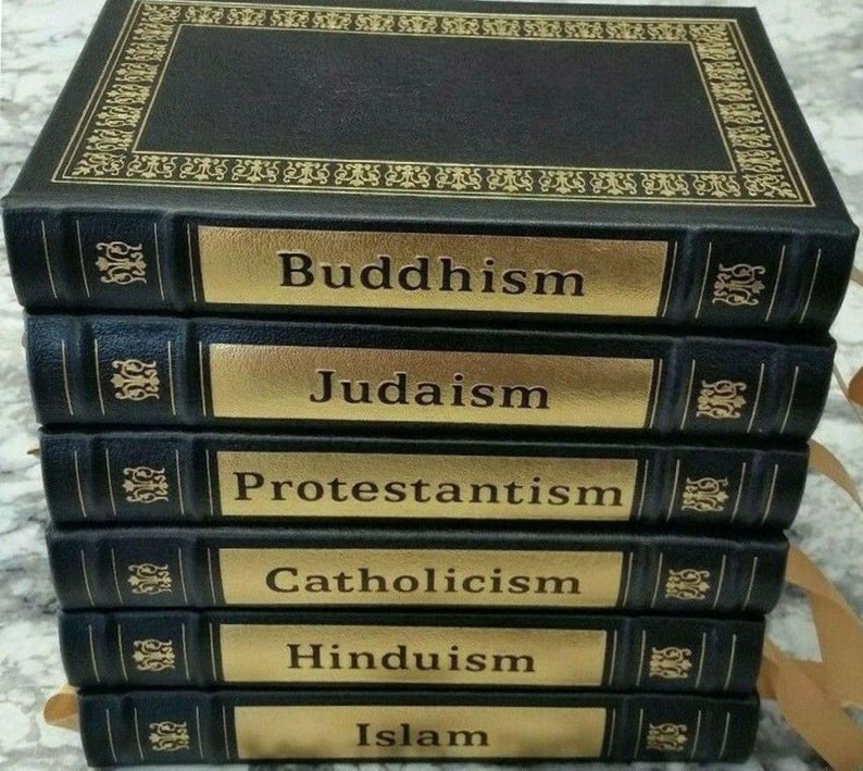 May include: A stack of six black books with gold lettering and accents. The titles on the spines read: Buddhism, Judaism, Protestantism, Catholicism, Hinduism, and Islam. The top book has an ornate gold border.
