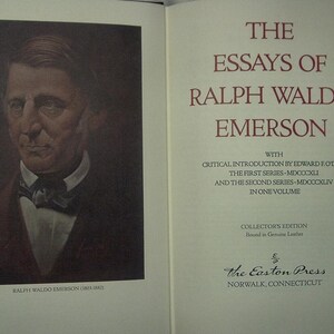 May include: An open book featuring a portrait of Ralph Waldo Emerson on the left page and the title "The Essays of Ralph Waldo Emerson" on the right. The book is a collector's edition bound in genuine leather.