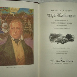 May include: A book cover with a portrait of Sir Walter Scott, the author of "The Talisman". The cover is illustrated with a scene from the book, featuring a knight on horseback. The book is part of "The 100 Greatest Books Ever Written" collection, published by The Easton Press.