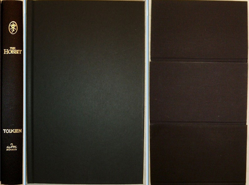 May include: A black hardback book with the title "The Hobbit" and the author's name "Tolkien" on the spine. The book is closed and the cover is plain black.