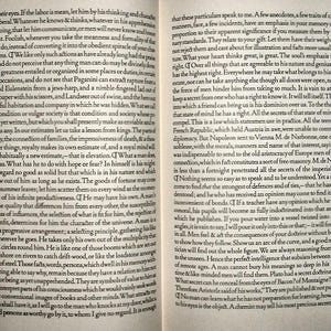 May include: Open book with text on two facing pages. The text is in English, with the title "The Essays of Ralph Waldo Emerson" and "Spiritual Laws" visible. The pages are aged, with visible text and a classic literary theme.