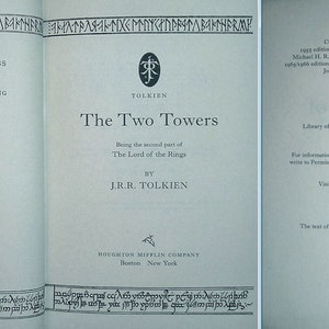 May include: The Two Towers, the second part of The Lord of the Rings by J.R.R. Tolkien. The book cover features a blue background with black text and a symbol of a tree with a ring.