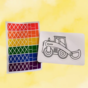 May include: A rainbow sticker sheet with a black and white outline of a construction vehicle. The vehicle has a large front blade and wheels.