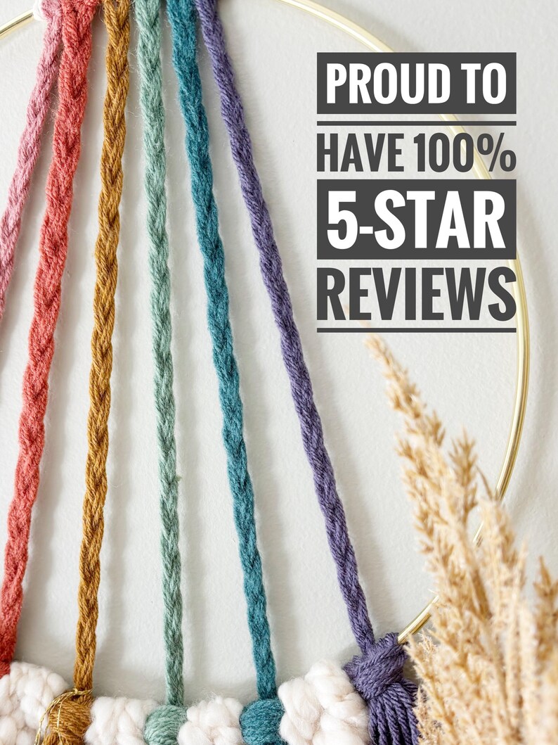 May include: A close-up of a macrame wall hanging with a gold metal ring and colorful braided cords in shades of pink, orange, green, teal, and purple. The text "PROUD TO HAVE 100% 5-STAR REVIEWS" is displayed in a black rectangle.