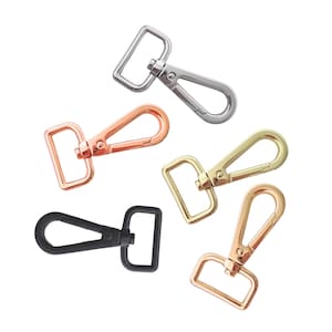 May include: An assortment of metal swivel clasps in various finishes, including silver, rose gold, gold, and black. These clasps feature a rectangular loop and a swivel hook, ideal for bag making and crafting projects.