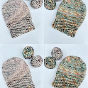 May include: Four knitted beanies in neutral and colorful yarns are displayed with matching yarn balls. The beanies have a ribbed brim and a small leather tag. The yarn balls are in shades of gray, teal, and brown.